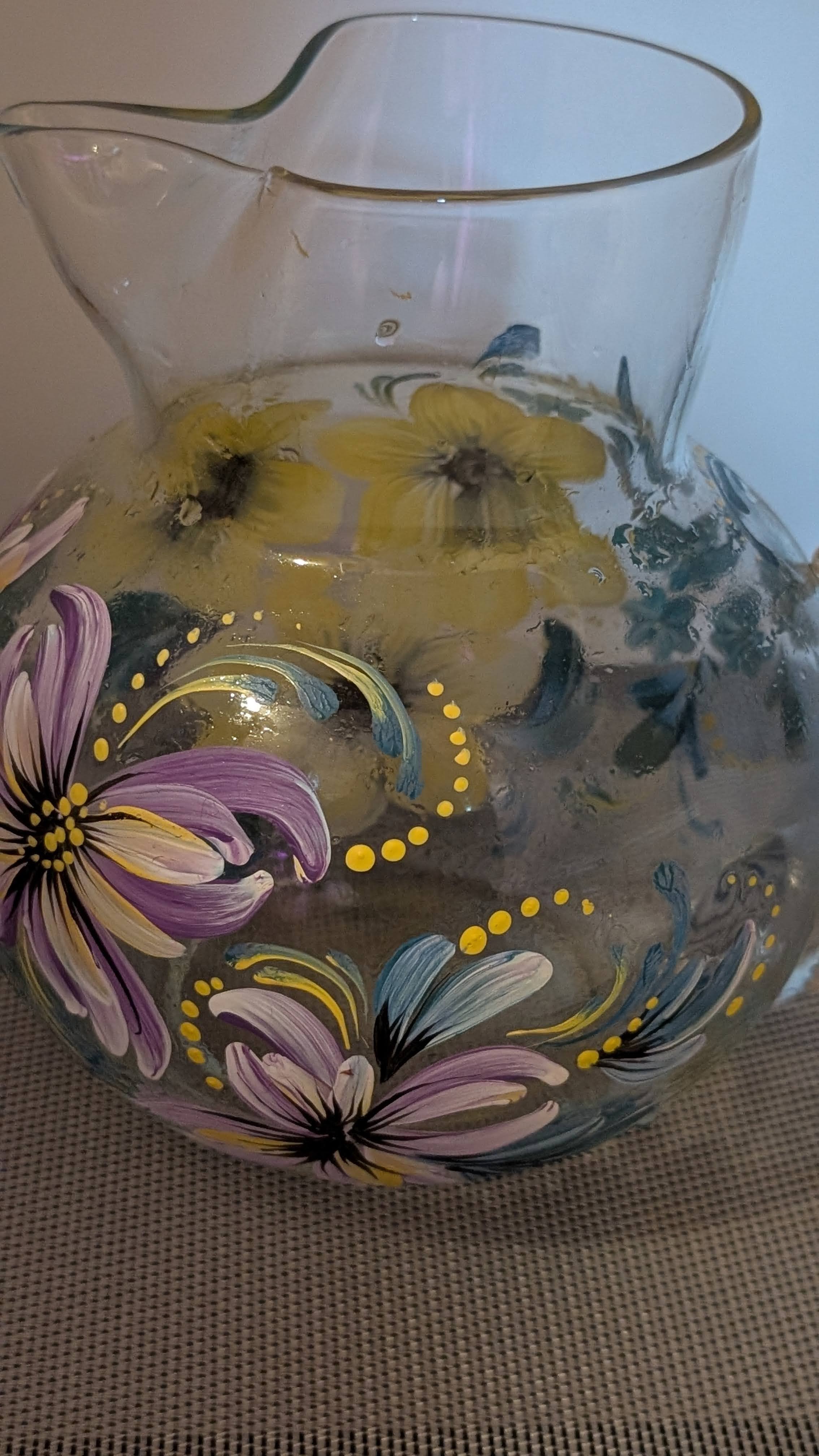 Decorative glass pitcher with purple and yellow florals